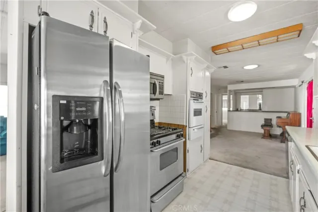 a kitchen with stainless steel appliances a refrigerator and stove