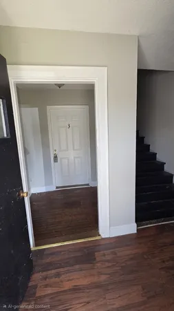 a view of a hallway with wooden floor and closet area