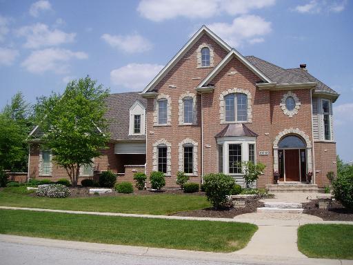 N183 Alexander Court Geneva, IL 60134 - Photo 1 of 1 a front view of a house with a yard