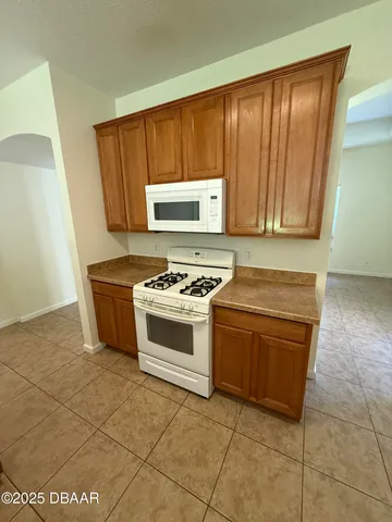 a kitchen with stainless steel appliances a stove a sink and a microwave
