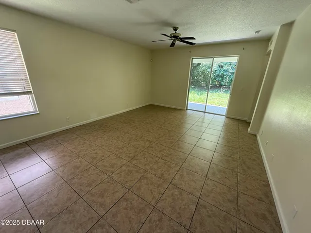 a view of an empty room and a window
