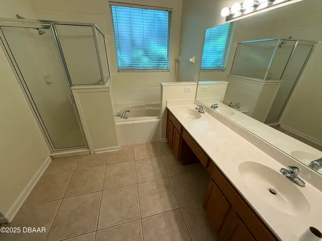 a bathroom with a sink a toilet a mirror and shower