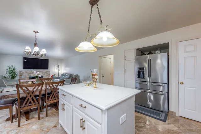 a kitchen with a table and chairs