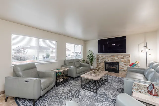 a living room with furniture flat screen tv and a fireplace