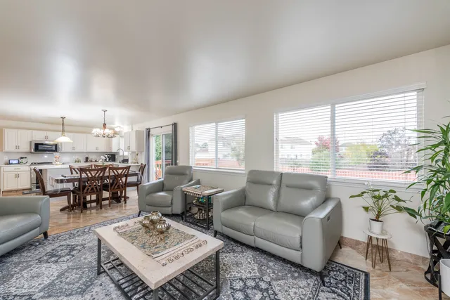 a living room with furniture potted plant and a large window