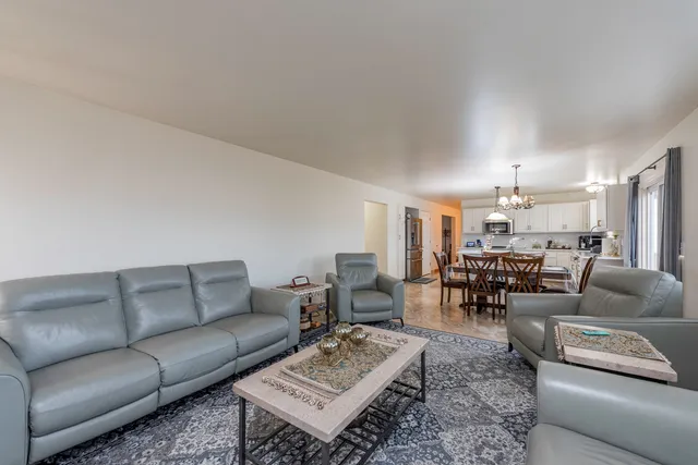 a living room with furniture and a chandelier