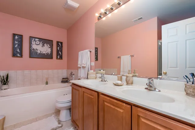 a bathroom with a double vanity sink and a bathtub