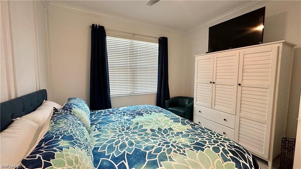 20015 Napa Loop Estero, FL 33928 - Photo 13 of 29 a bedroom with a bed and a flat screen tv