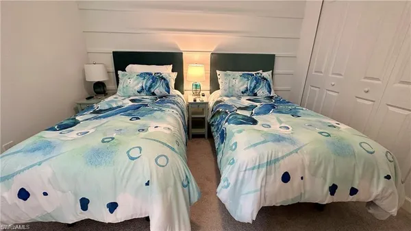 a bedroom with a bed and flat screen tv