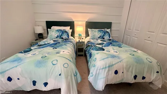 a bedroom with a bed and flat screen tv