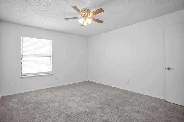 a view of a room with a ceiling fan