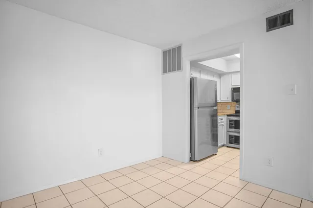 a kitchen with cabinets stainless steel appliances and a sink
