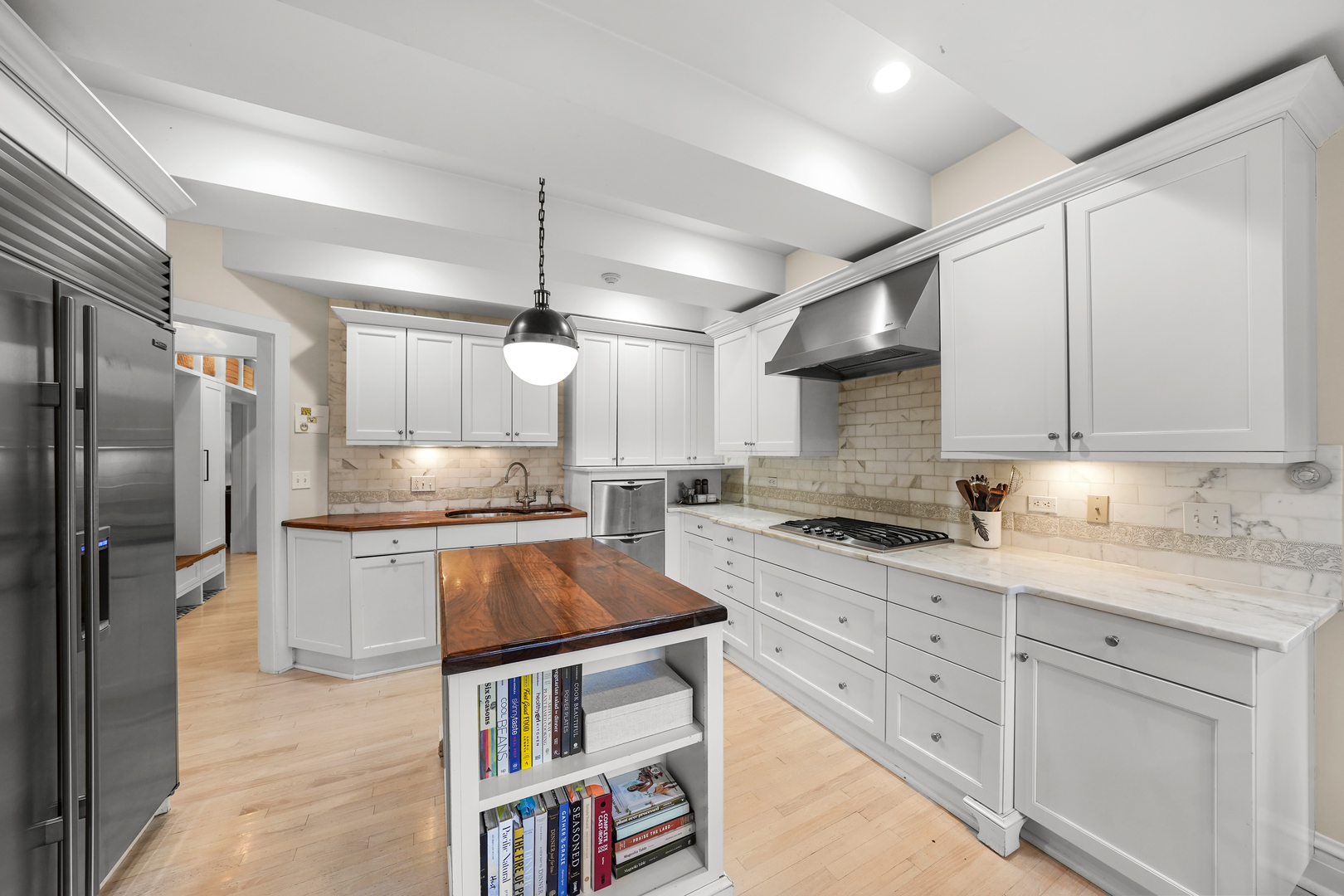 475 Cedar Street Winnetka, IL 60093 - Photo 15 of 46 a kitchen with stainless steel appliances granite countertop a refrigerator a sink dishwasher a stove and white cabinets with wooden floor