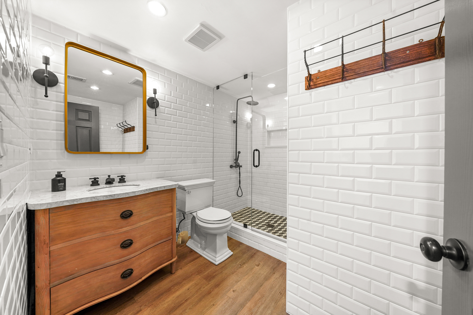 475 Cedar Street Winnetka, IL 60093 - Photo 36 of 46 a bathroom with a toilet sink a mirror and shower