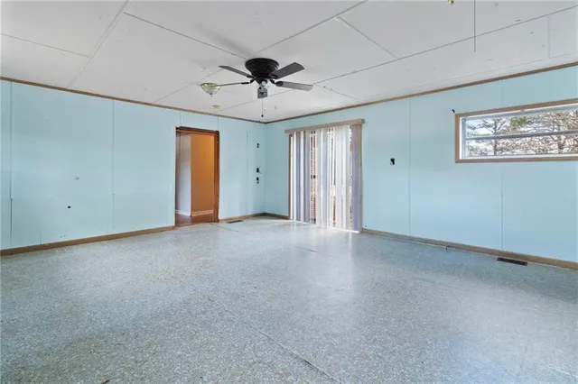 a view of an empty room with a ceiling fan