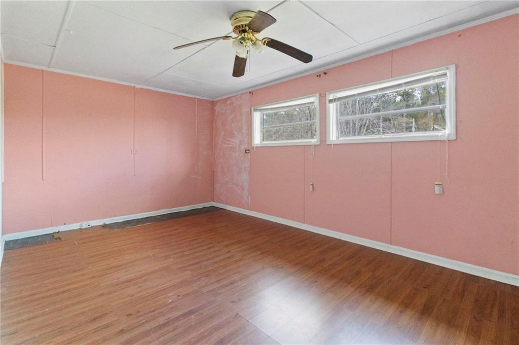 74 Hulsey Road Cedartown, GA 30125 - Photo 21 of 36 a view of an empty room with window and wooden floor