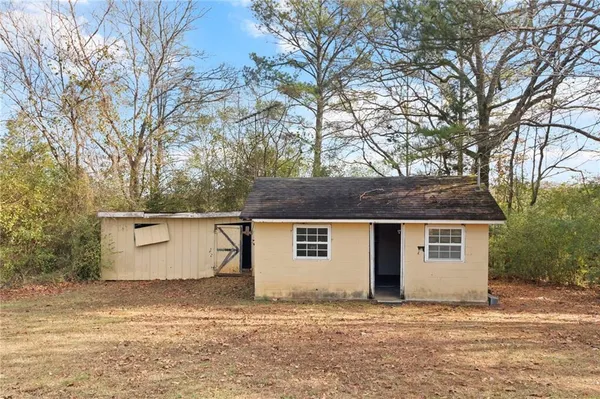 a house that has a tree in front of it
