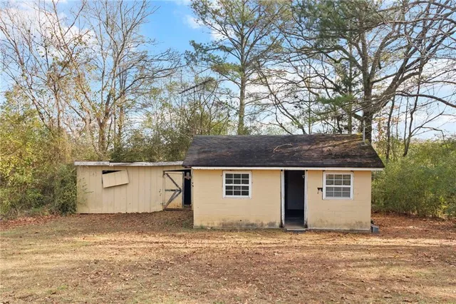 a house that has a tree in front of it