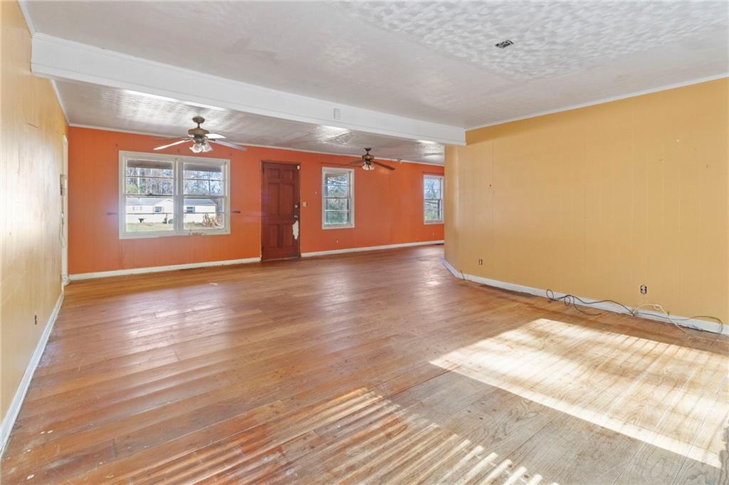 74 Hulsey Road Cedartown, GA 30125 - Photo 6 of 36 a view of an empty room with window and wooden floor