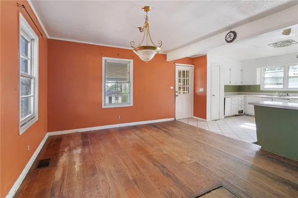 a view of a kitchen with wooden floor and windows