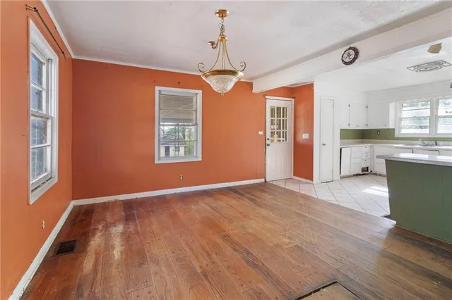 a view of a kitchen with wooden floor and windows