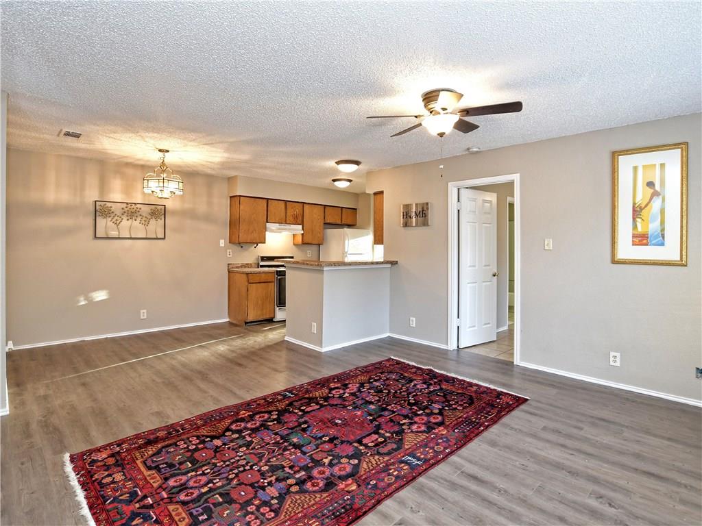5401 Spring Meadow Road, Unit B Austin, TX 78744 - Photo 5 of 21 An open concept living area transitions seamlessly into a well-appointed kitchen.