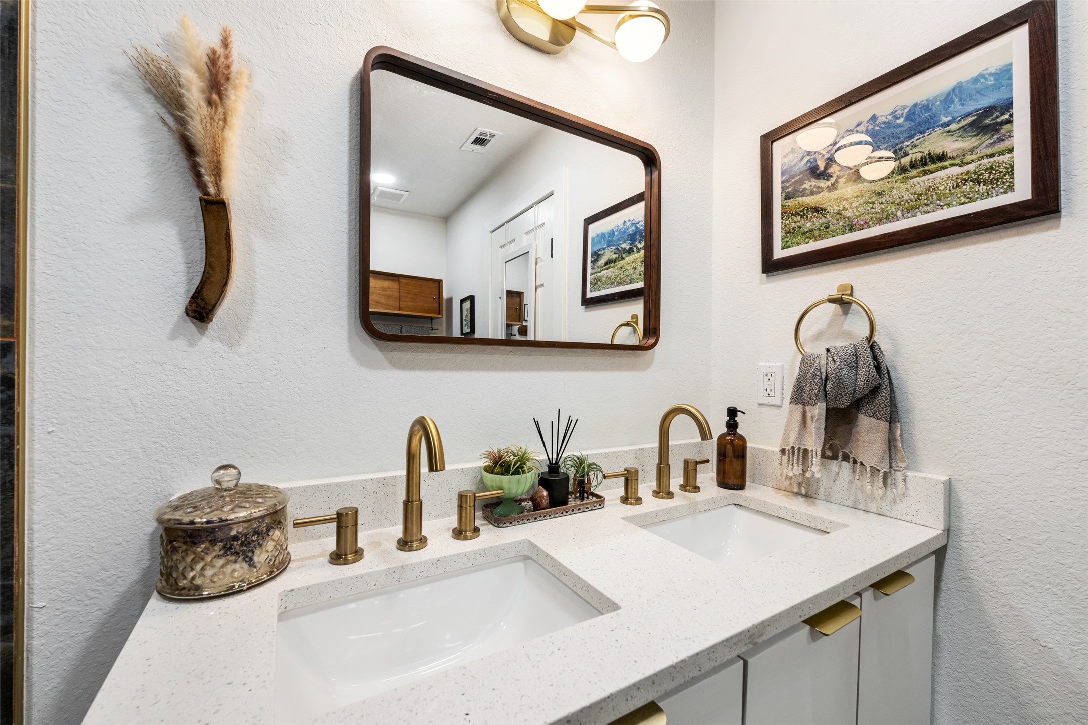 1616 Webberville Road, Unit A Austin, TX 78721 - Photo 22 of 35 Bathroom featuring double vanity and a textured wall
