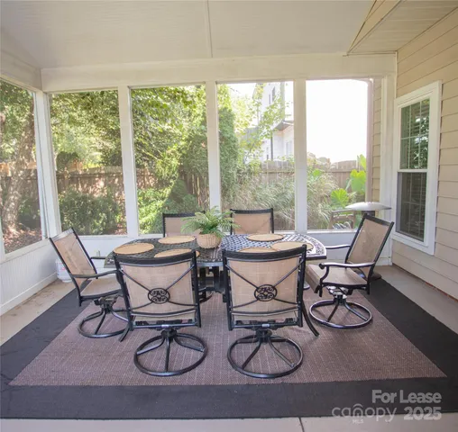 a dining room with furniture water view and wooden floor
