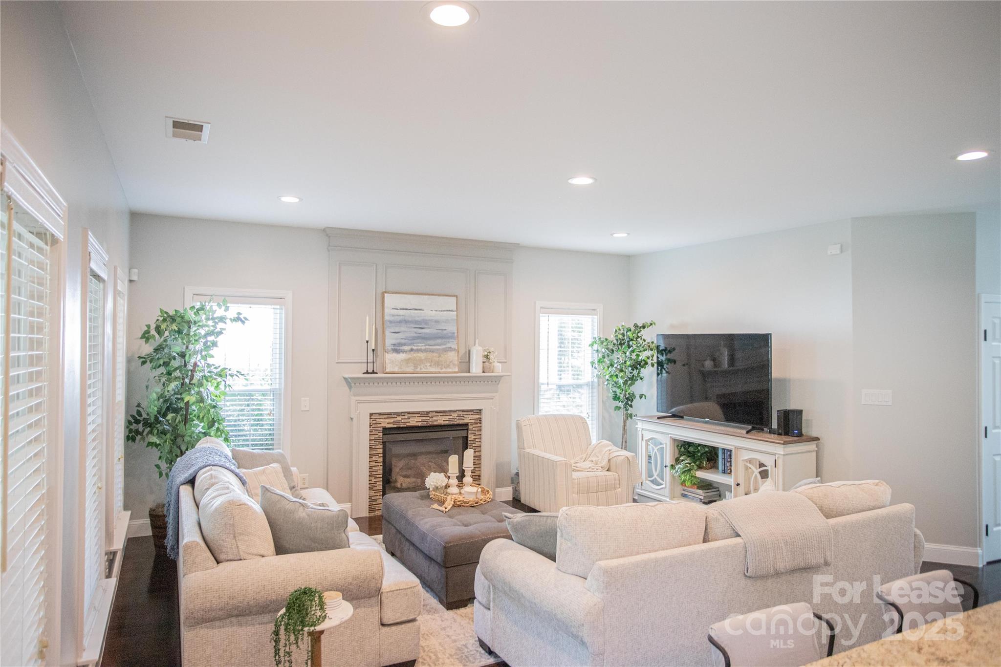 615 Circle Trace Road Monroe, NC 28110 - Photo 10 of 16 a living room with furniture a flat screen tv and a fireplace