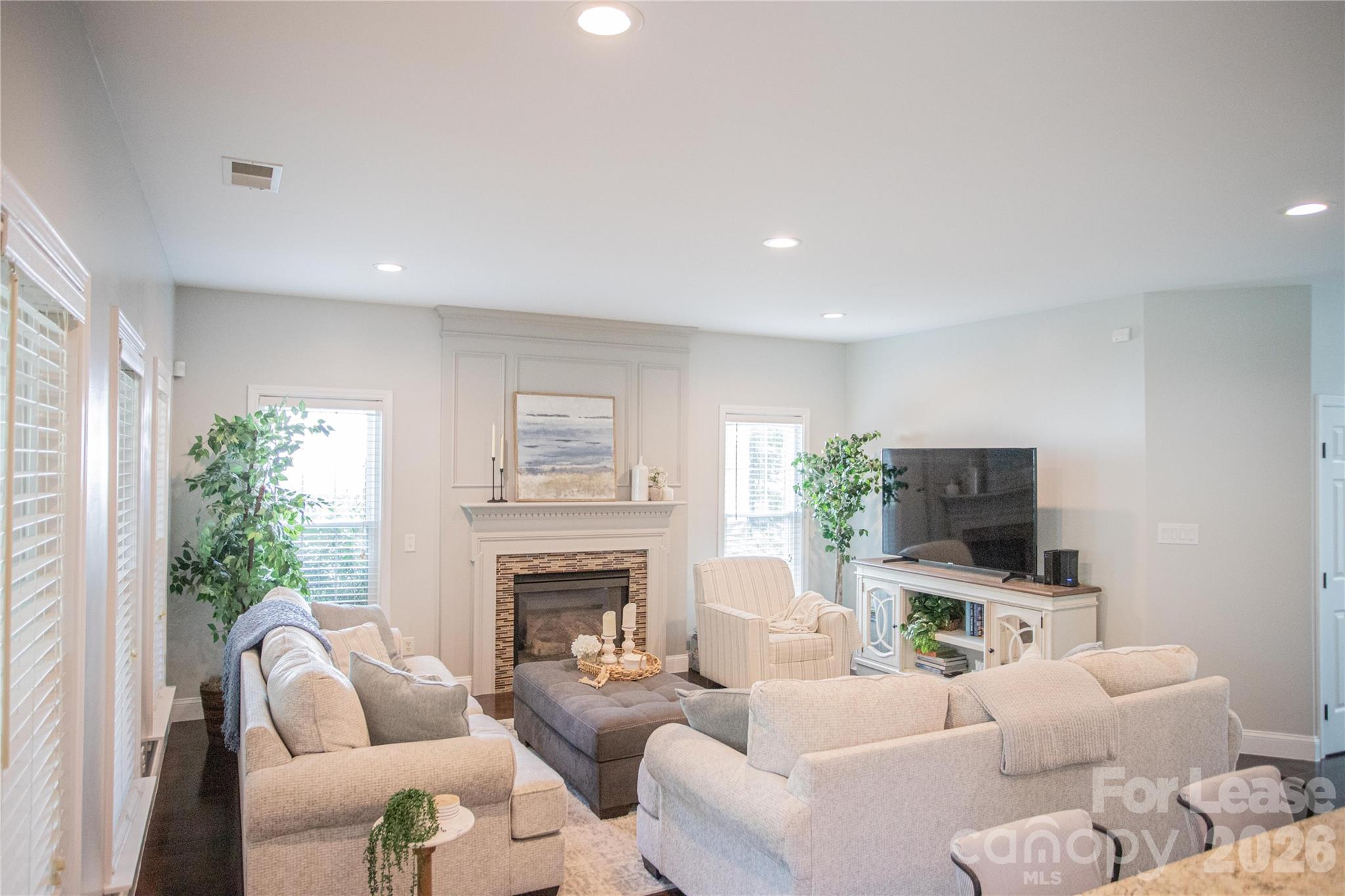615 Circle Trace Road Monroe, NC 28110 - Photo 10 of 16 a living room with furniture a fireplace and a flat screen tv