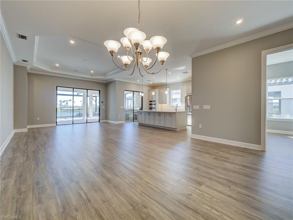 15107 Pescara Street Naples, FL 34114 - Photo 14 of 31 a view of an empty room with wooden floor and fan