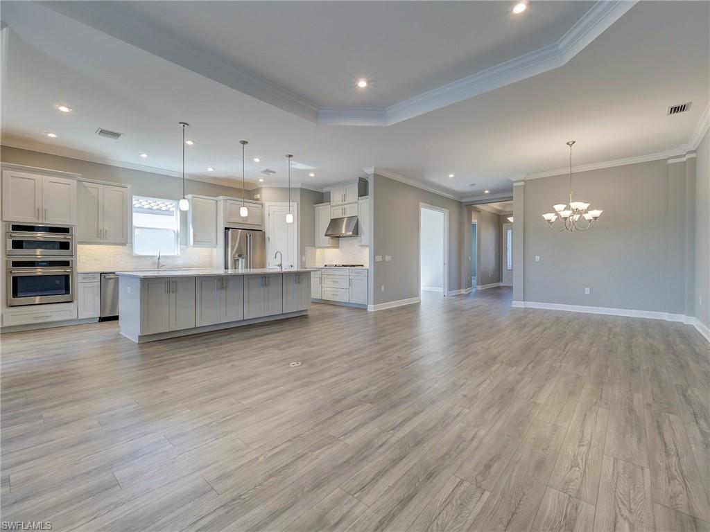 15107 Pescara Street Naples, FL 34114 - Photo 15 of 31 a view of kitchen and wooden floor