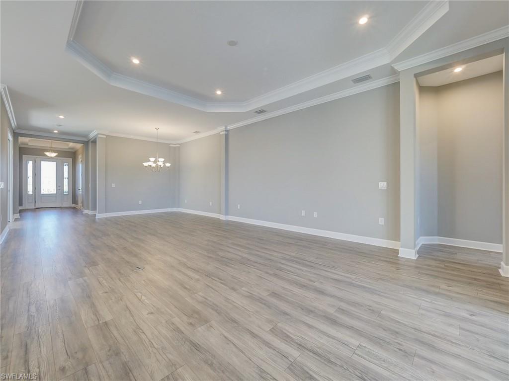 15107 Pescara Street Naples, FL 34114 - Photo 21 of 31 a view of an empty room with wooden floor