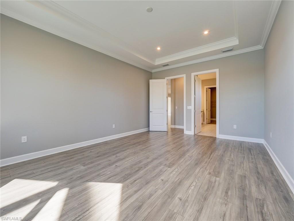 15107 Pescara Street Naples, FL 34114 - Photo 23 of 31 a view of an empty room with wooden floor and a window