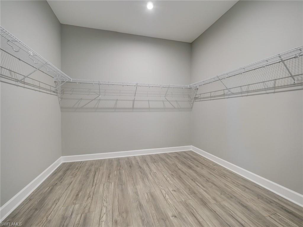 15107 Pescara Street Naples, FL 34114 - Photo 26 of 31 a view of a room with wooden floor