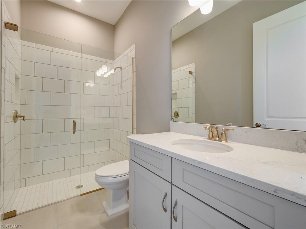 15107 Pescara Street Naples, FL 34114 - Photo 29 of 31 a bathroom with a sink a toilet and shower