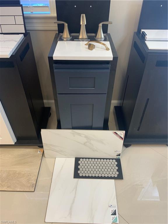 15107 Pescara Street Naples, FL 34114 - Photo 4 of 31 a bathroom with a sink and a mirror