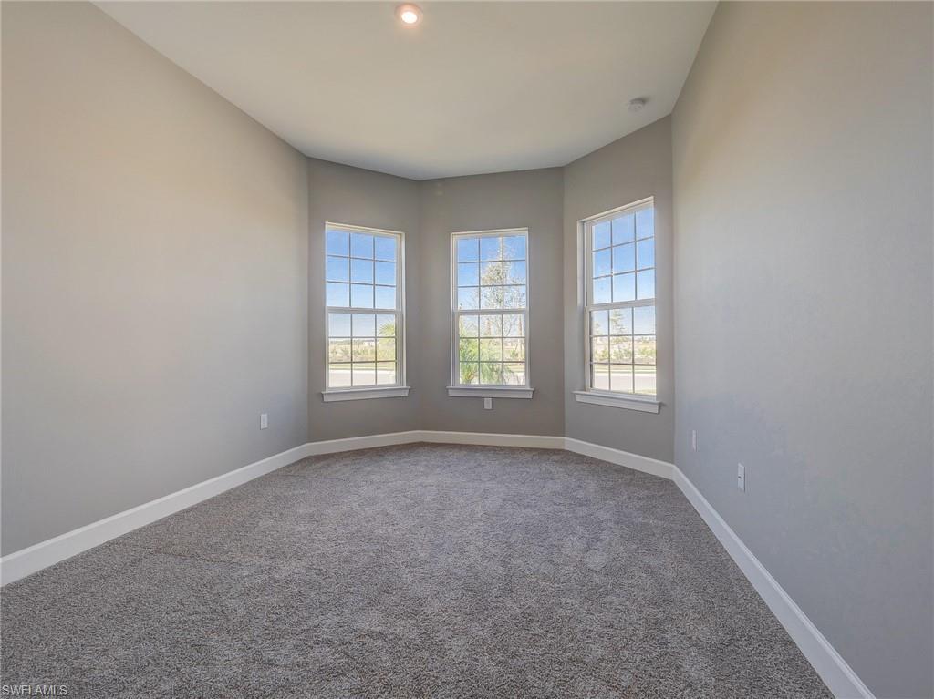 15107 Pescara Street Naples, FL 34114 - Photo 8 of 31 an empty room with windows