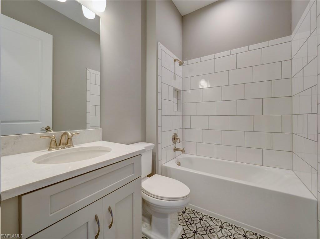 15107 Pescara Street Naples, FL 34114 - Photo 10 of 31 a bathroom with a sink a toilet and a bathtub