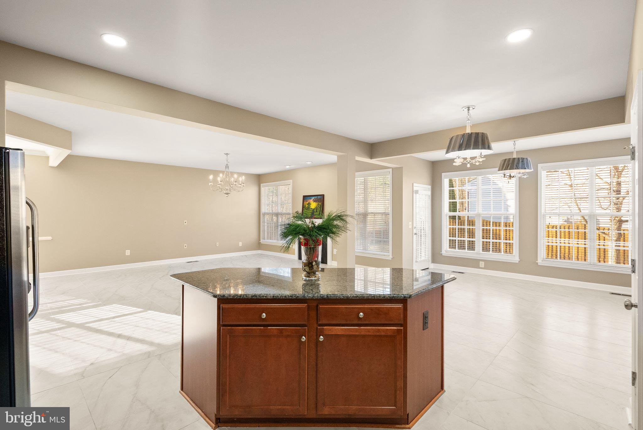 7722 Yalta Way Gainesville, VA 20155 - Photo 23 of 75 a kitchen with stainless steel appliances granite countertop a sink and a granite counter tops