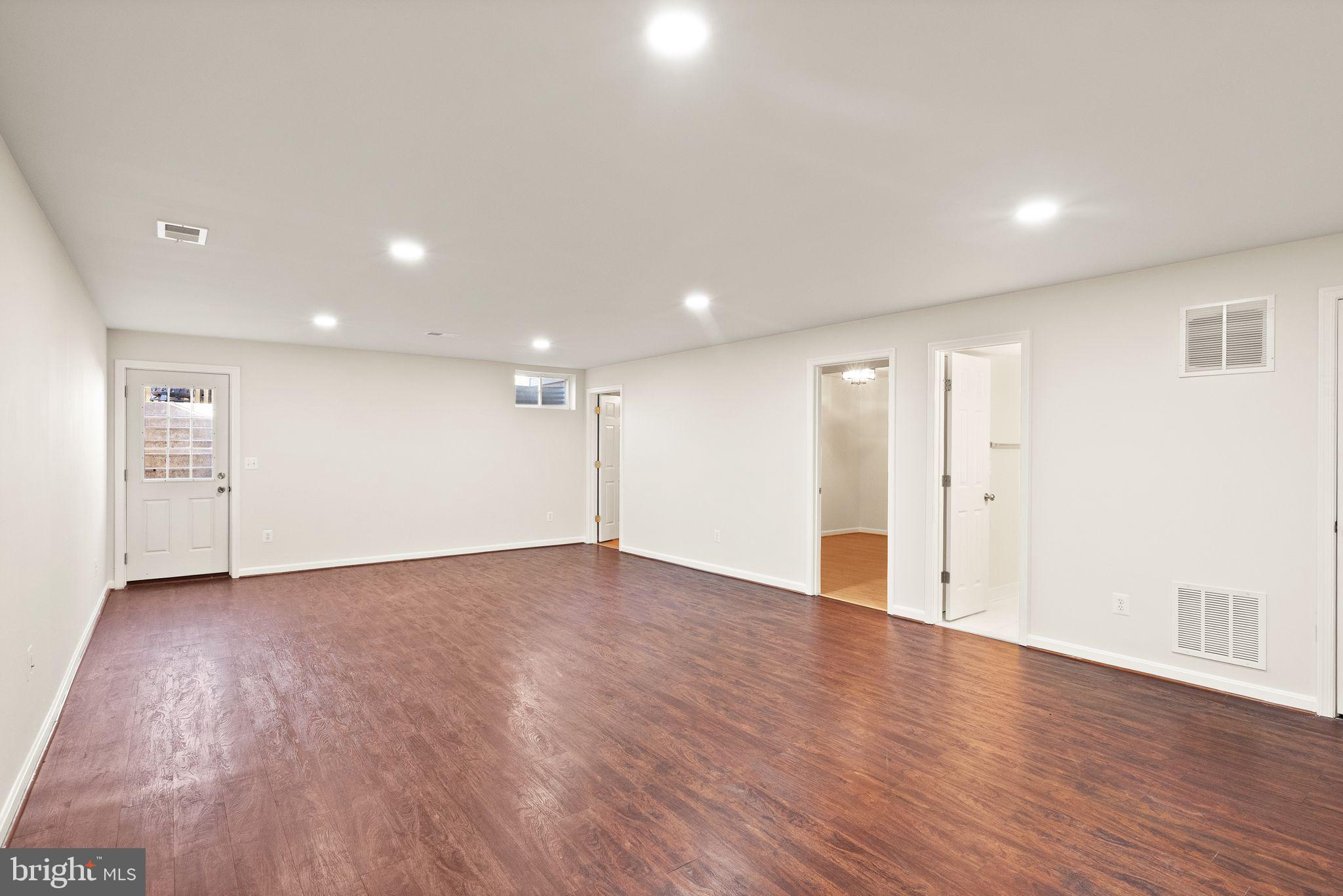 7722 Yalta Way Gainesville, VA 20155 - Photo 54 of 75 a view of an empty room with wooden floor
