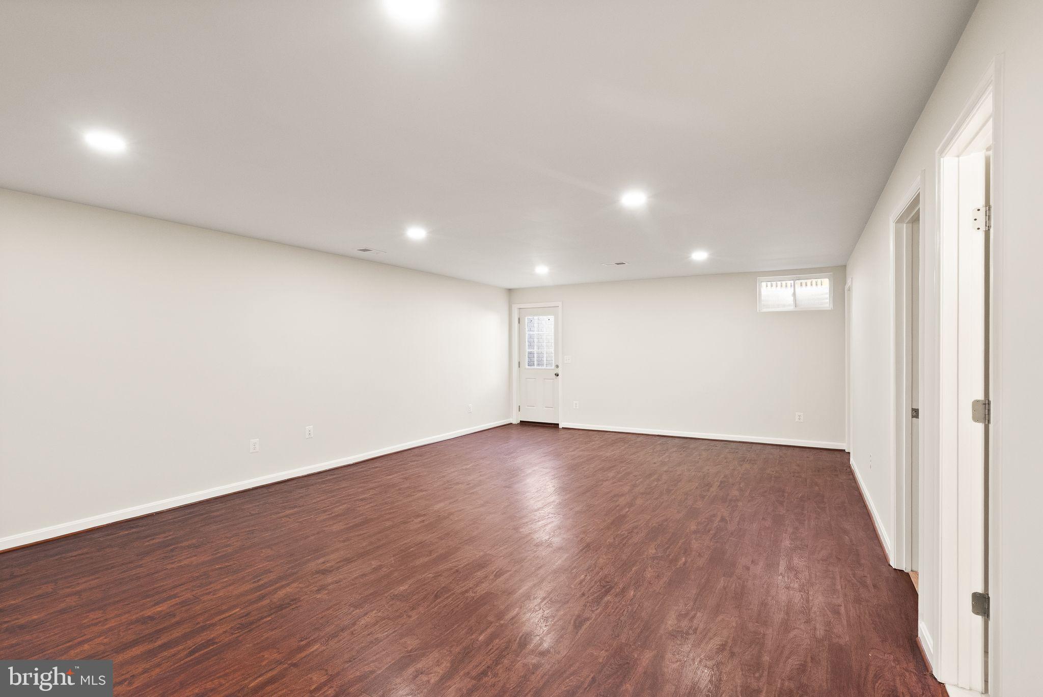 7722 Yalta Way Gainesville, VA 20155 - Photo 55 of 75 an empty room with wooden floor and windows