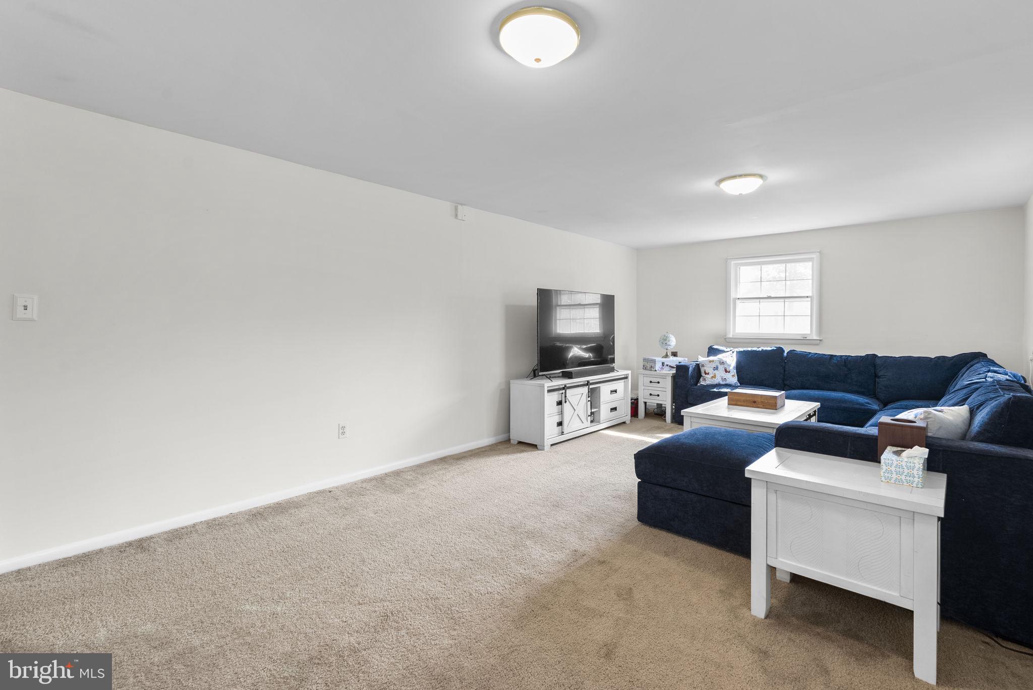 712 Petersburg Road Davidsonville, MD 21035 - Photo 25 of 37 a living room with furniture and a flat screen tv