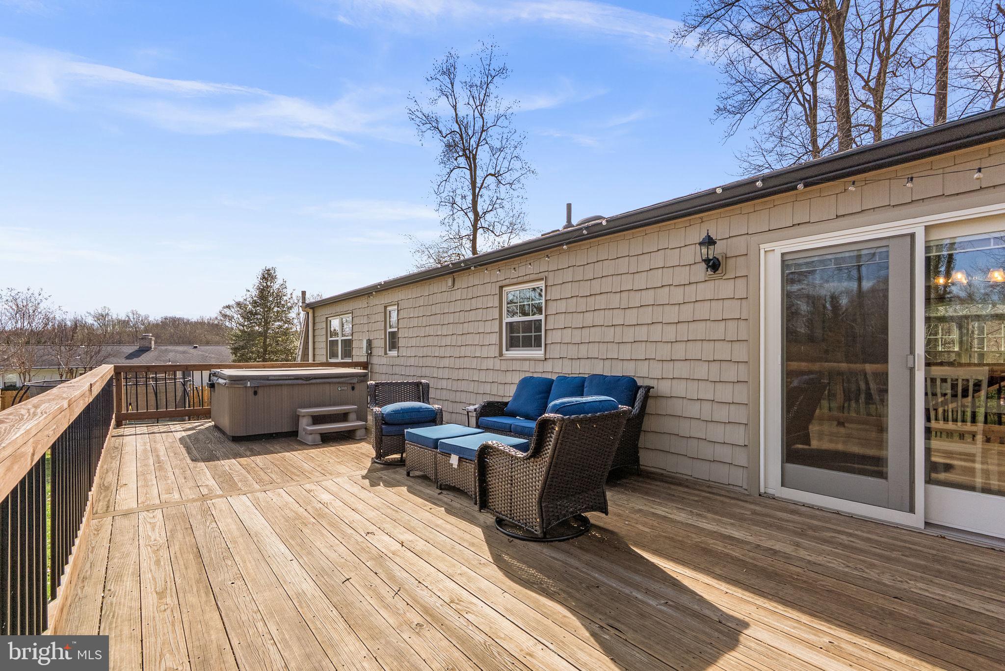 712 Petersburg Road Davidsonville, MD 21035 - Photo 28 of 37 a view of a roof deck with table and chairs a barbeque with wooden floor and fence