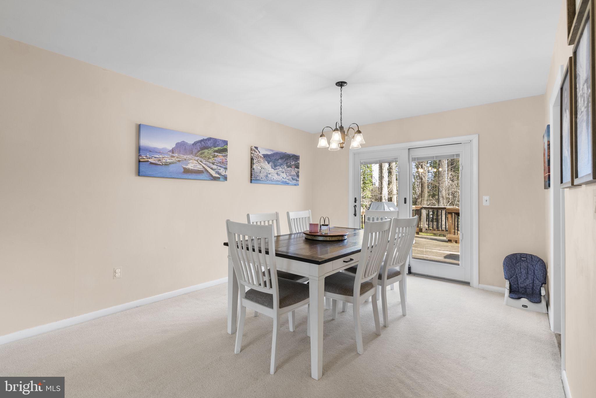 712 Petersburg Road Davidsonville, MD 21035 - Photo 7 of 37 a view of a dining room with furniture and chandelier