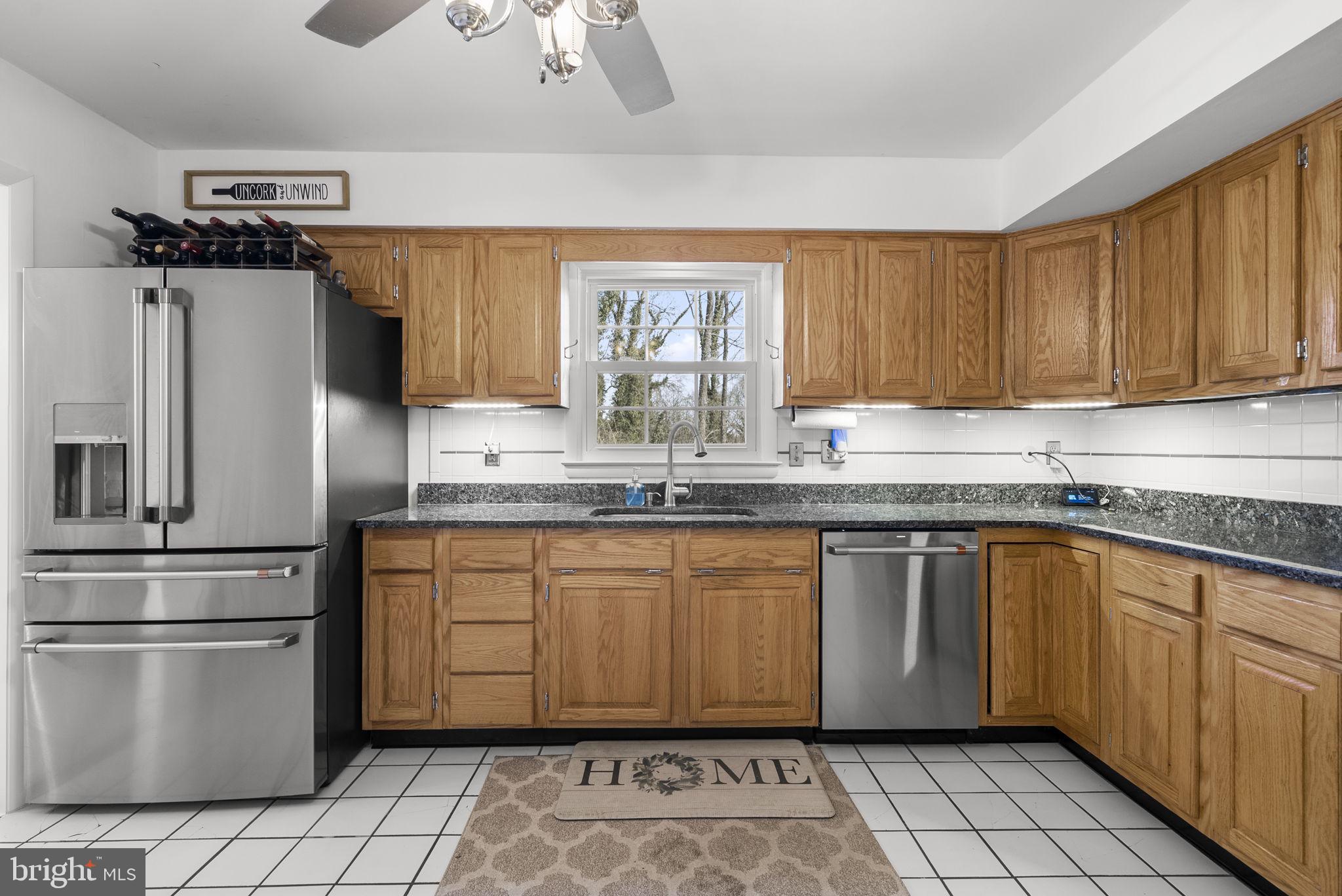 712 Petersburg Road Davidsonville, MD 21035 - Photo 10 of 37 a kitchen with granite countertop a sink stainless steel appliances and cabinets