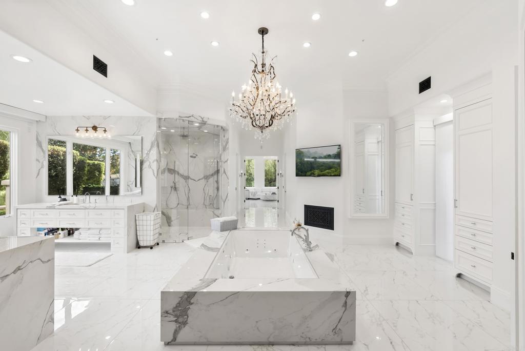 6853 Rancho Valencia Road Rancho Santa Fe, CA 92067 - Photo 14 of 40 a large living room with fireplace furniture and a chandelier