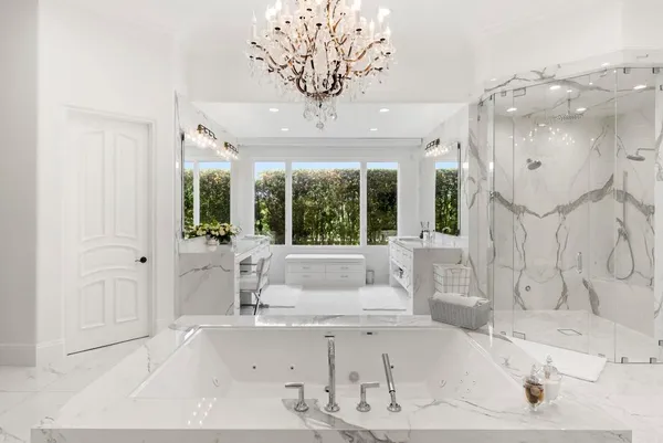 a bathroom with a tub sink and large window