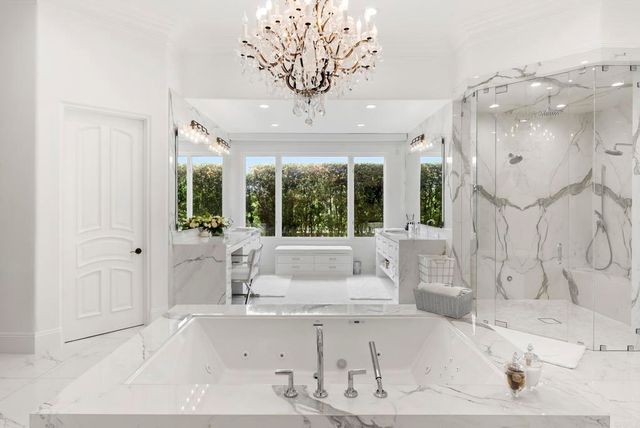 a bathroom with a tub sink and large window