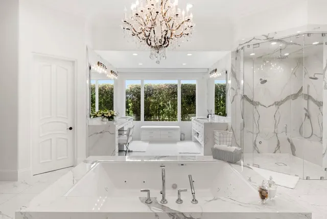 a bathroom with a tub sink and large window